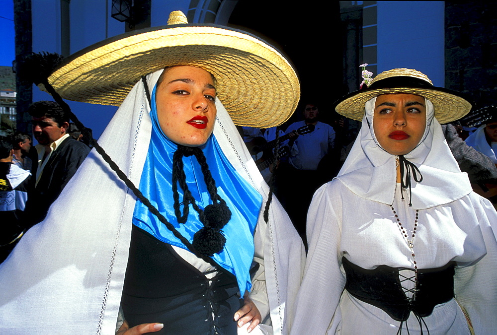 Two women in traditional clothes at the festival of the almond flower, Folklore music, Canary Islands, Spain