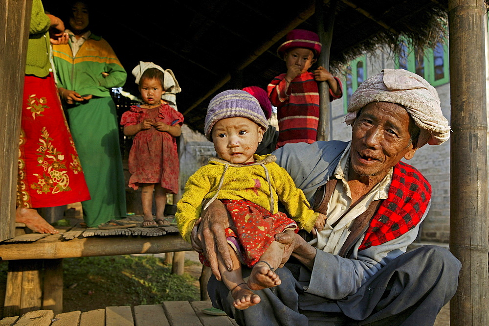 Portrait grandfather holding child, hill tribe, Burma, Myanmar