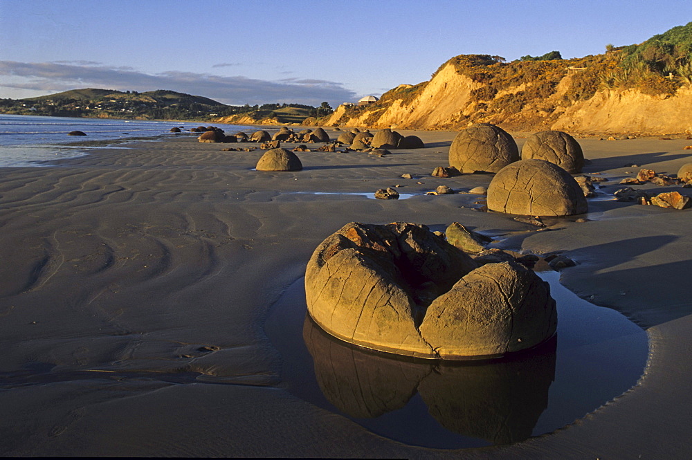 Moeraki boulders on the beach in the sunlight, South Island, New Zealand, Oceania