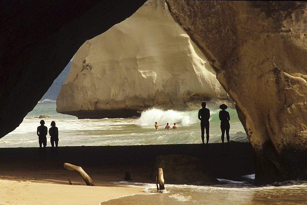 People on the beach in Cathedral Cave at Coromandel Peninsula, North Island, New Zealand, Oceania