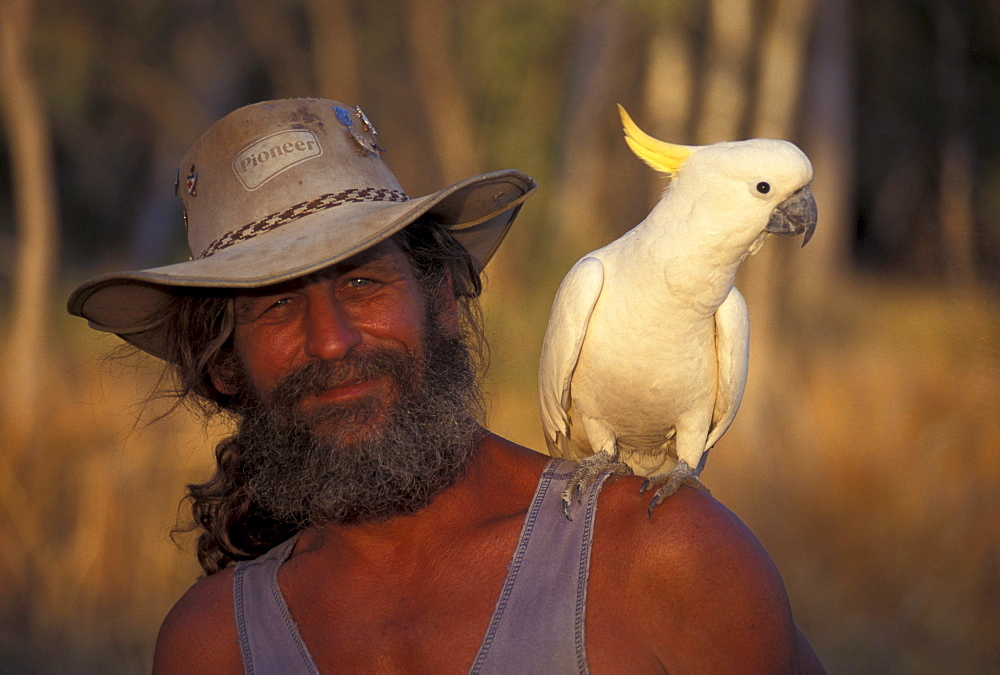 Bushman with cockatoo, Austrailian Bush, Australia