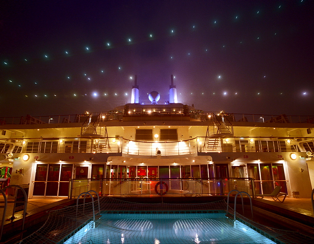 Illuminated deck and pool, Cruise ship Queen Mary 2