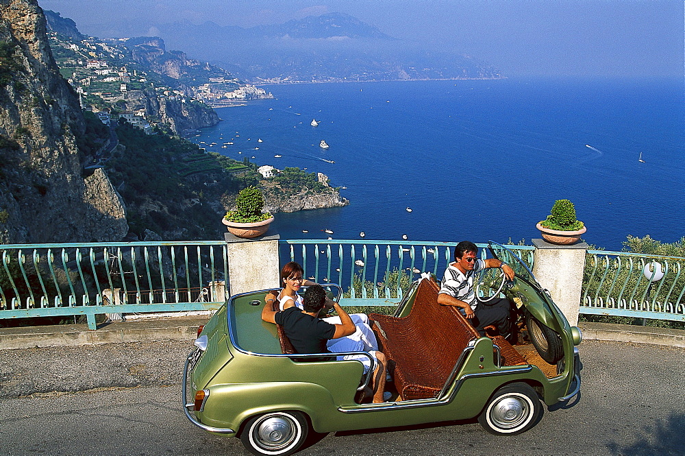 People in a vintage car at the coast in the sunlight, Amalficoast, Campania, Italy, Europe