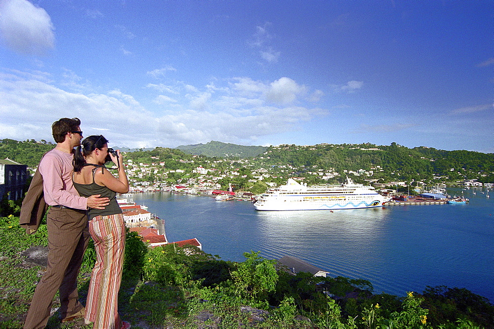 Couple photographing cruise ship AIDA at harbour, St. GeorgeÂ¥s, Grenada, Caribbean, America