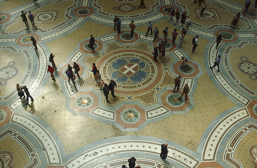 People in Galleria Vittorio Emanuele II, floor mosaic, Milan, Italy