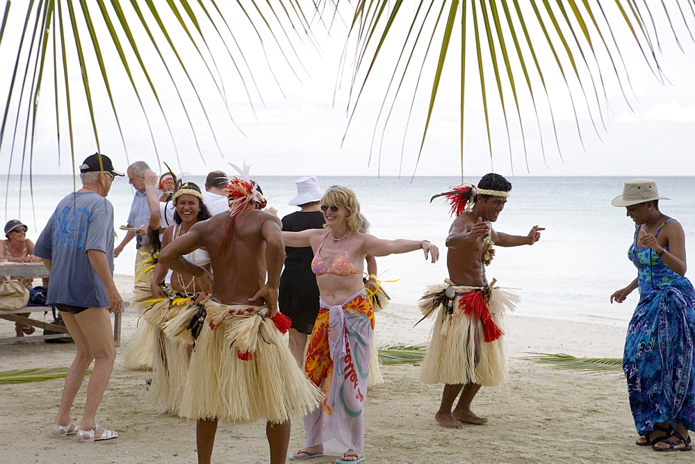 Passengers from the Cruiseship Star Flyer (Star Clippers Cruises) dancing with locals at a beach barbecue party, Fakarava, The Tuamotus, French Polynesia