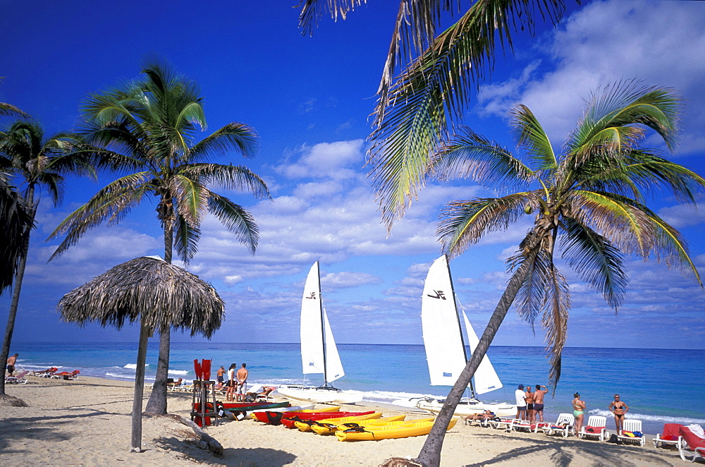 People and sailing boat on the beach, Playas del Este, Cuba, Caribbean, America