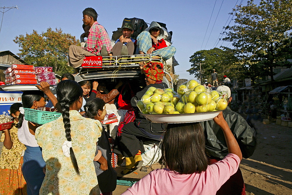 Women selling fruit at country bus station, Myanmar