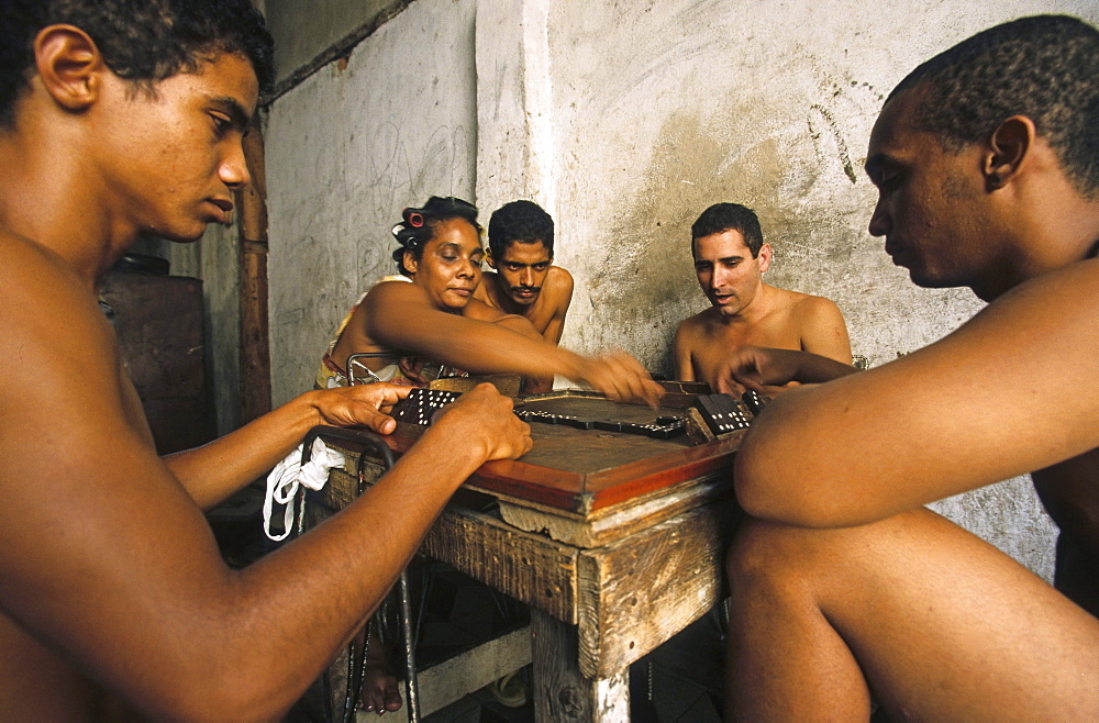 small group playing dominoes in heat of day, Cuba