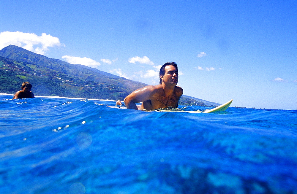 Surfer waiting for a wave, Punaauia, Tahiti, French Polynesia, South Pacific