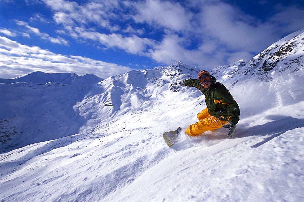 Snowboarder going downhill, Serfaus, Tyrol, Austria