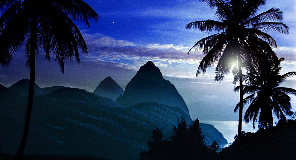 Palm trees and the mountains Two Pitons at moonrise, Soufriere, St. Lucia, Carribean, America