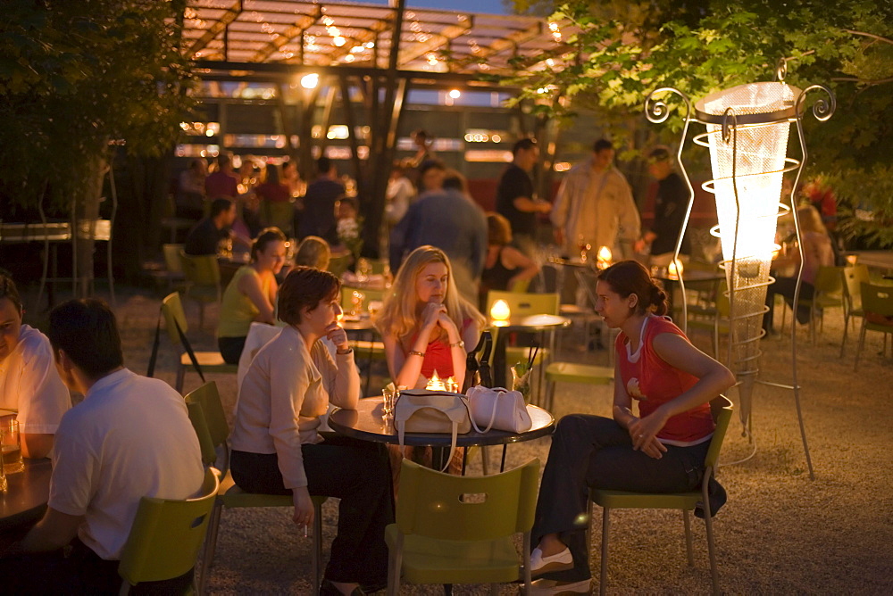 Girls in the open-air nightclub Zoeld Pardon, Young girls sitting in the open-air nightclub Zoeld Pardon, near the Petoefi Bridge, Buda, Budapest, Hungary