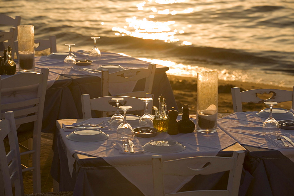 Table with glasses and plates at bank, Little Venice, Mykonos-Town, Mykonos, Greece