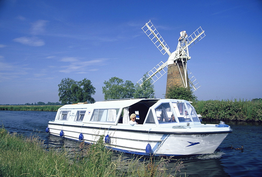 Leisure boats on canal next to How Hill windpump, Norfolk Broads, England00058427