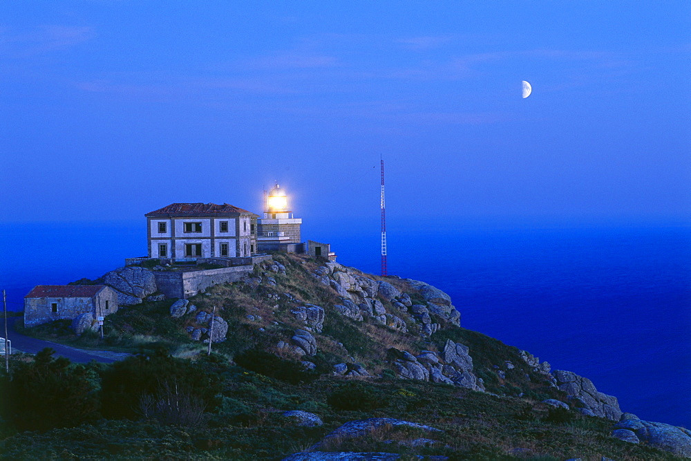 Lighthouse and moon, Cabo Finisterre, Province La Coruna, Galicia, Spain