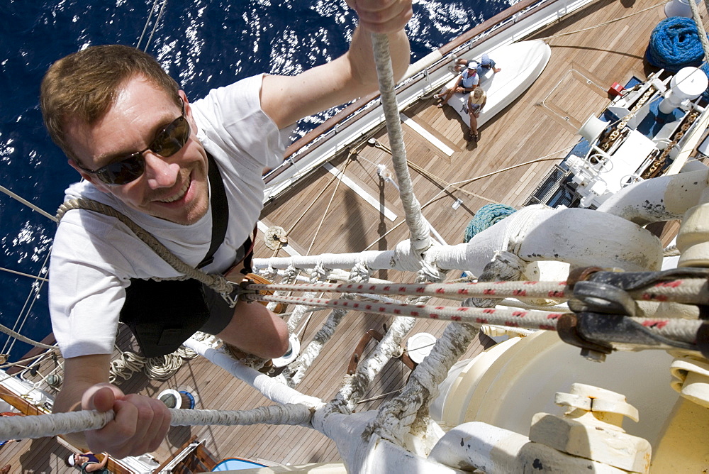 Man climbing a mast on the Star Clipper, Caribbean Sea