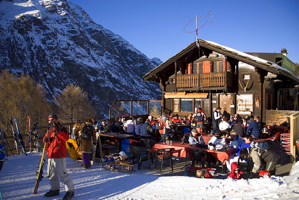 People sitting on terrace of the mountain restaurant "Othmar's Huette", Sunnegga Paradise, Zermatt, Valais, Switzerland