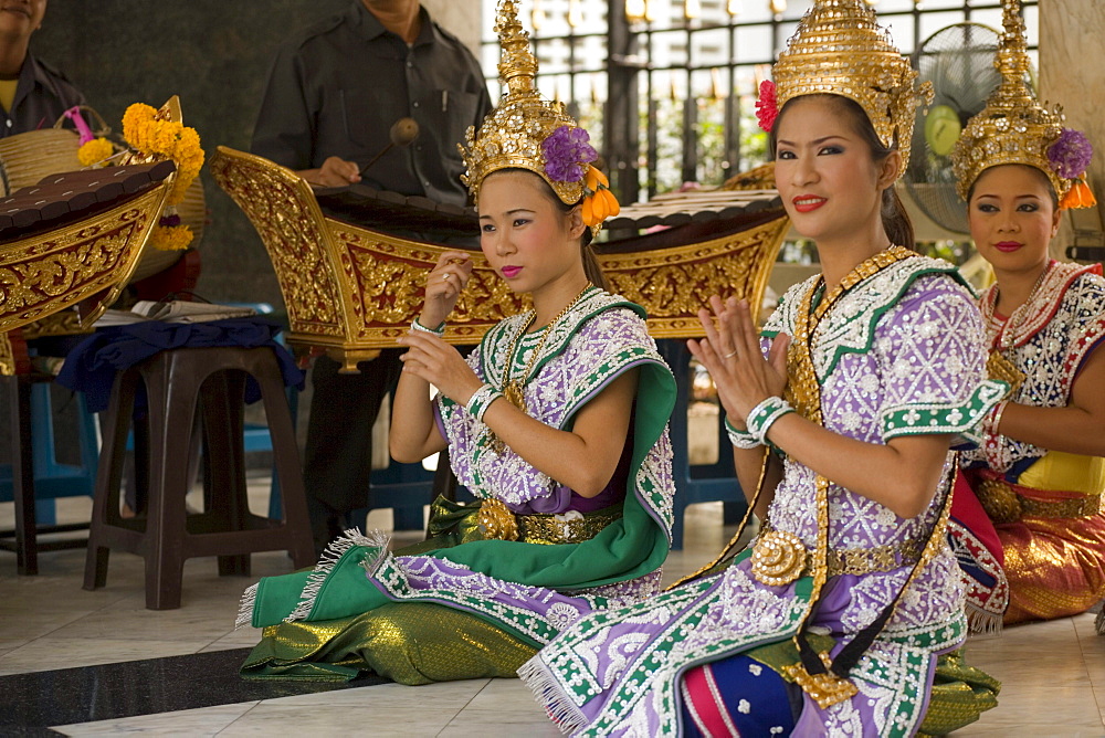 Traditional Thai dancers performing for Brahma, they dancing on request for donations, Erawan Shrine, Ratchadamri Road near Siam Square, Pathum Wan District, Bangkok, Thailand