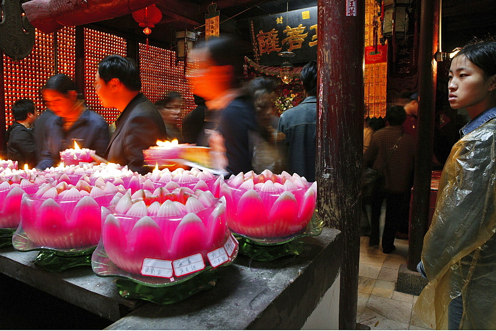 Pilgrims lighting up candles in the form of lotus flowers, Longevity monastery, Jiuhua Shan, Anhui province, China, Asia