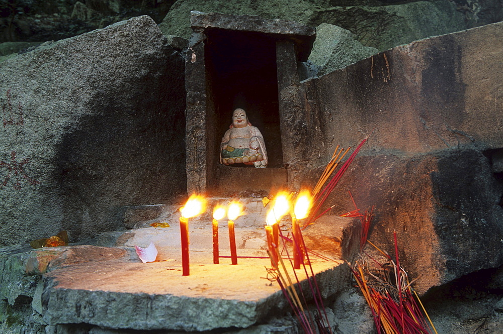 Shrine next to Thousand stone steps stairway, Buddha statue, candles and incense in stone altar, Buddhist Island of Putuo Shan near Shanghai, Zhejiang Province, East China Sea, China, Asia