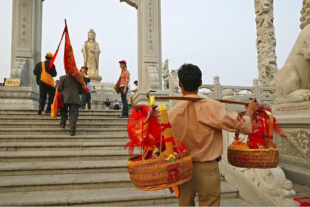 Buddha statues from house altars brought to Guanyin, pilgrims, Goddess of Mercy, Buddhist Island of Putuo Shan near Shanghai, Zhejiang Province, East China Sea, China, Asia