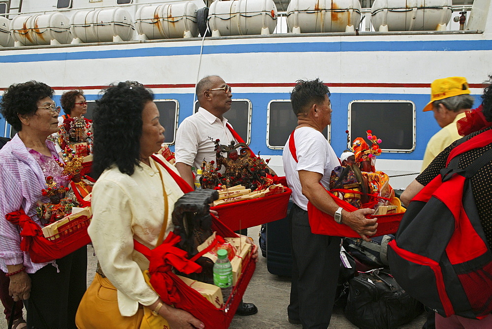 pilgrims at ferry, Buddha statues from house altars brought to Guanyin, Goddess of Mercy, Buddhist Island of Putuo Shan near Shanghai, Zhejiang Province, East China Sea, China, Asia