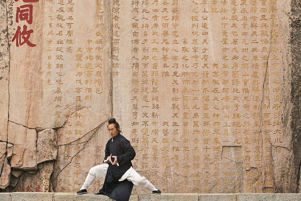 Taoist monk Zhang Qingren demonstrating Tai Ch infront of a famous inscription from Emperor Xuanzong, Hou Shi Wu Temple, Mount Tai, Tai Shan, Shandong province, World Heritage, UNESCO, China