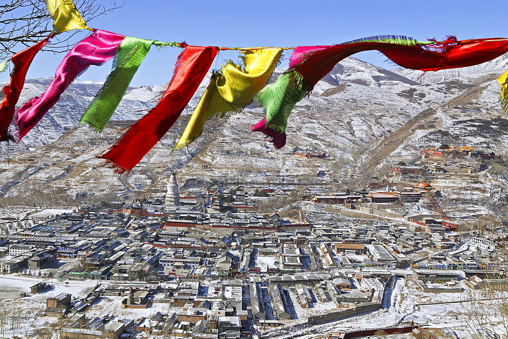 Tibetan prayer flags, view above the town of Taihuai and Wutai Shan Mountains in winter, Mount Wutai, Shanxi province, China