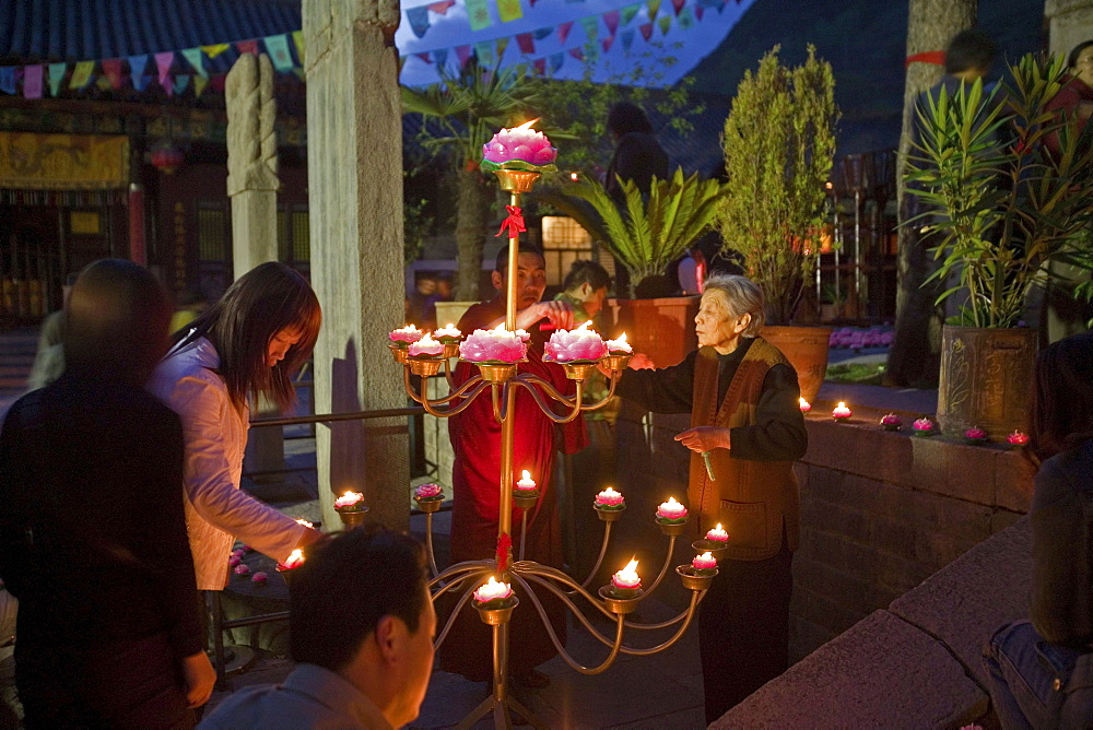 Lighting the candles during the birthday celebrations for Wenshu, Shuxiang temple, Mount Wutai, Wutai Shan, Five Terrace Mountain, Buddhist Centre, town of Taihuai, Shanxi province, China