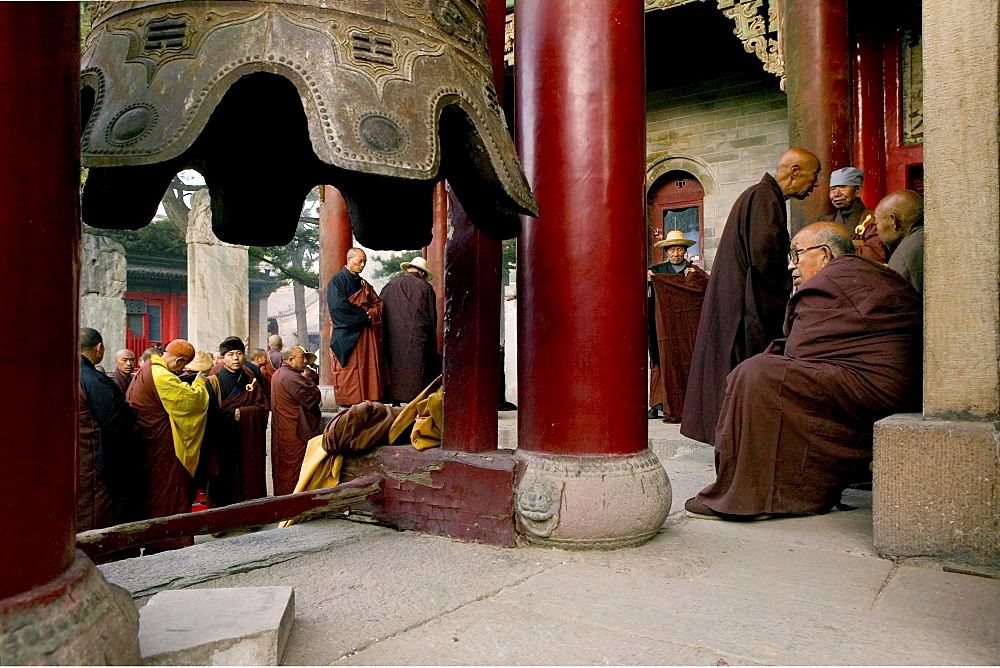 Buddhist monks honouring Wenshus at the birthday celebrations, red columns of temple, Xiantong Monastery, Wutai Shan, Five Terrace Mountain, Buddhist Centre, town of Taihuai, Shanxi province, China