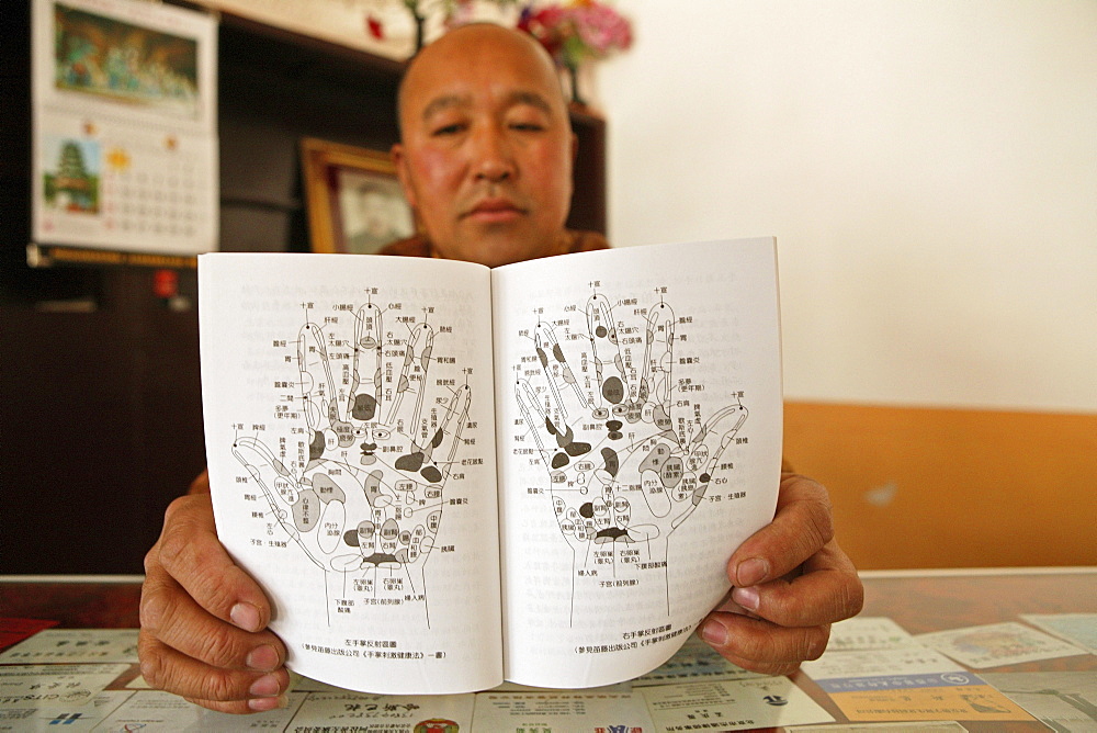 Monk holding diagram for massage, Luohou monastery, Taihuai, Mount Wutai, Wutai Shan, Five Terrace Mountain, Buddhist Centre, town of Taihuai, Shanxi province, China