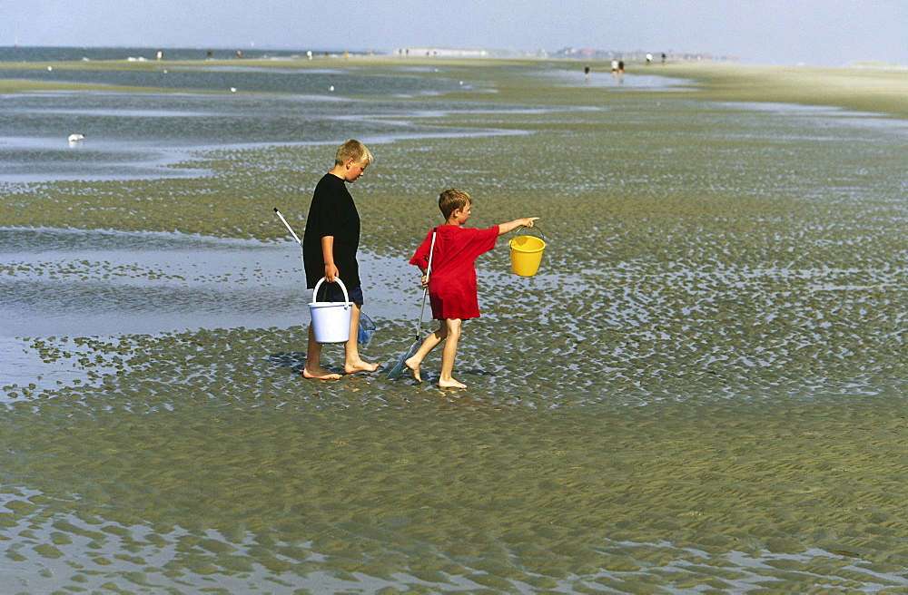 Children in mudflat, Norderney, East Frisia, Germany