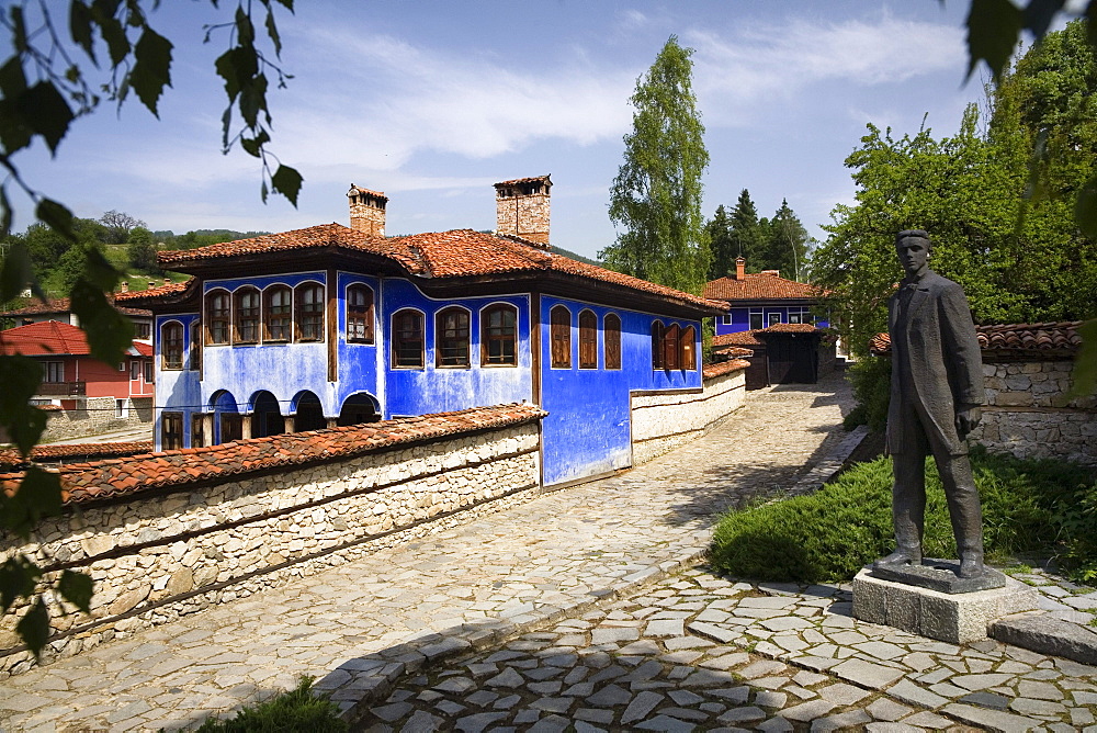 Blue house and statue, museum town Koprivstiza, Bulgaria, Europe