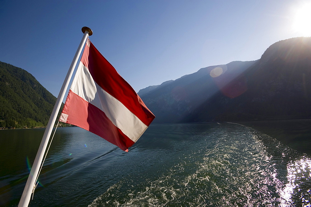 Austrian flag at stern of a ship on Lake Hallstatt, Hallstatt, Salzkammergut, Upper Austria, Austria