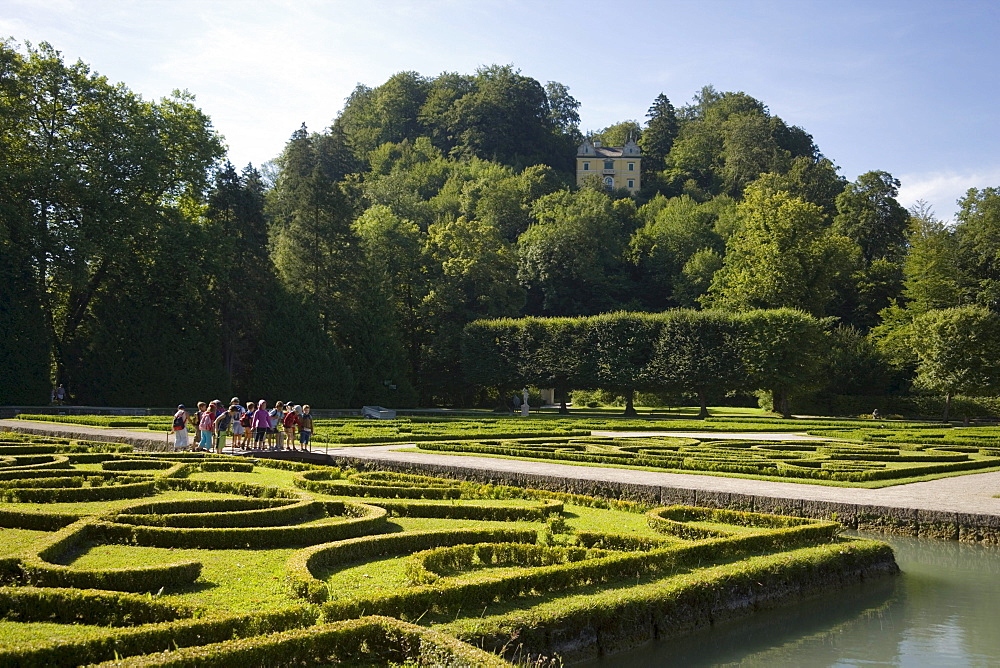 Group of children visiting water parterre, Month Palace in background, Hellbrunn Palace, oldest baroque palace site north of the Alps, Salzburg, Salzburg, Austria