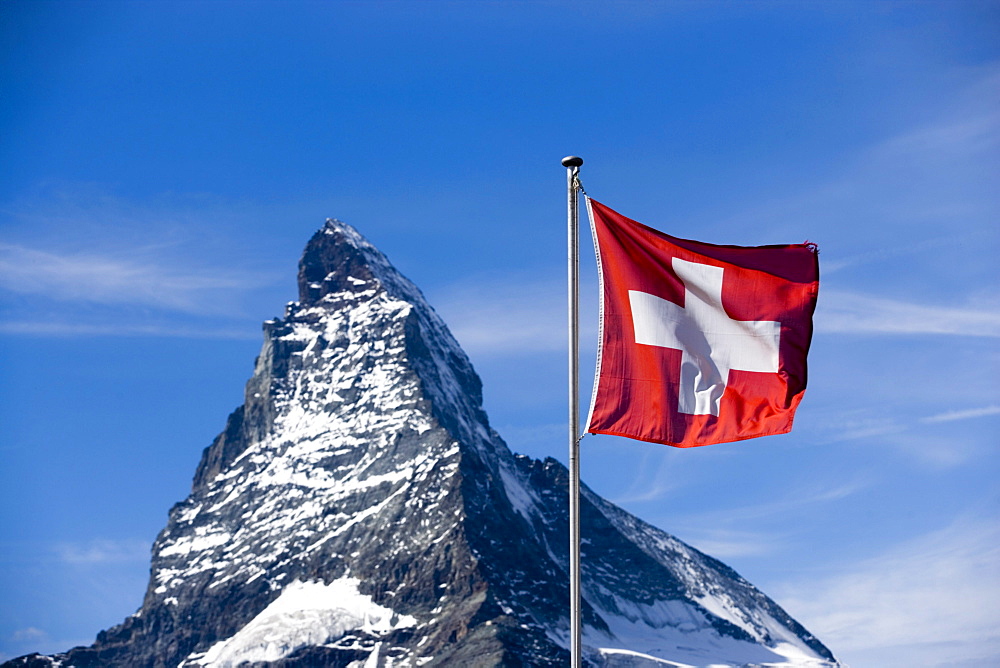 Swiss flag in front of the Matterhorn (4478 metres), Zermatt, Valais, Switzerland