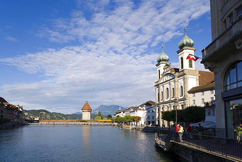 View along river Reuss with Jesuit Curch, first large sacral baroque building in Switzerland, and Kapellbruecke (chapel bridge, oldest covered bridge of Europe) with Wasserturm, Lucerne, Canton Lucerne, Switzerland