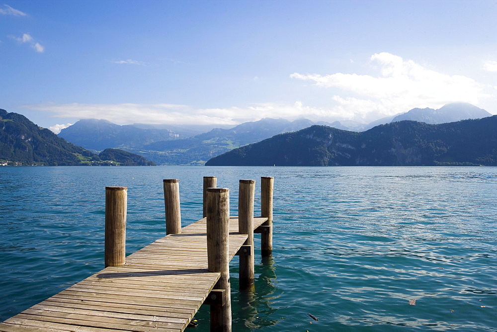 View from a wooden footbridge over Lake Lucerne with mountains in background, Weggis, Canton of Lucerne, Switzerland