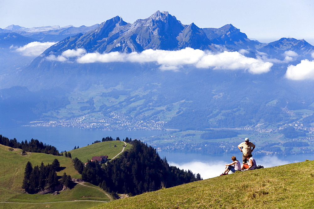 Three people on Rigi Kulm (1797 m) enjoying view over Lake Lucerne to Pilatus (2132 m), Rigi Kulm, Canton of Schwyz, Switzerland