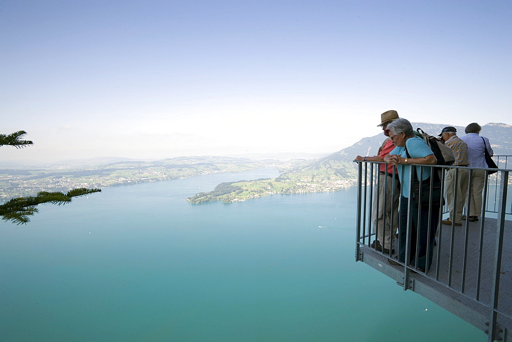 People standing at vantage point of Felsenweg and looking over Lake Lucerne, Buergenstock (1128 m), Buergenstock, Canton Nidwalden, Switzerland