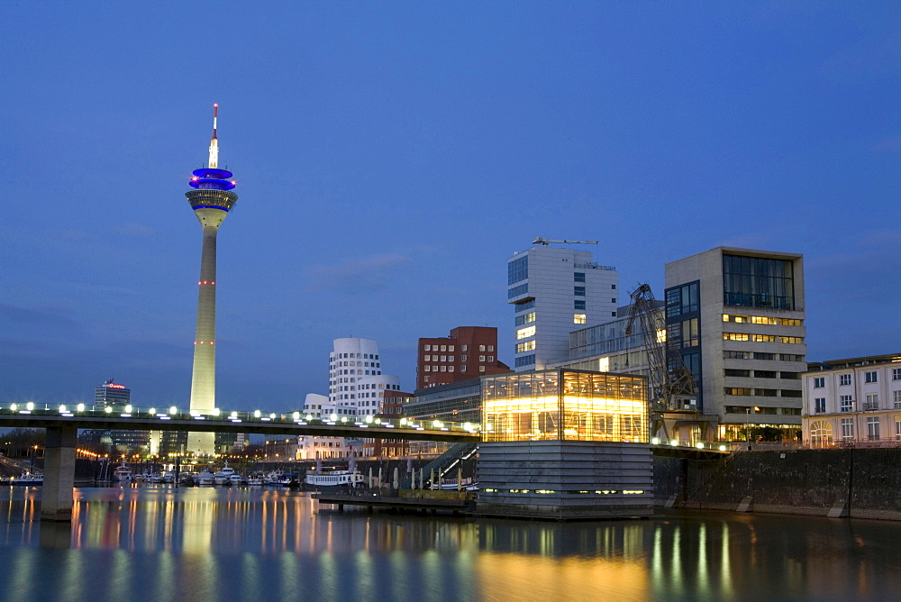 Modern architecture in the Media Harbour with television tower in the evening, Duesseldorf, state capital of NRW, North-Rhine-Westphalia, Germany