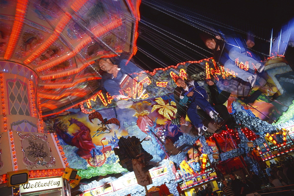 People on a swing carousel, chair-o-plane at the Octoberfest, Munich, Bavaria, Germanys