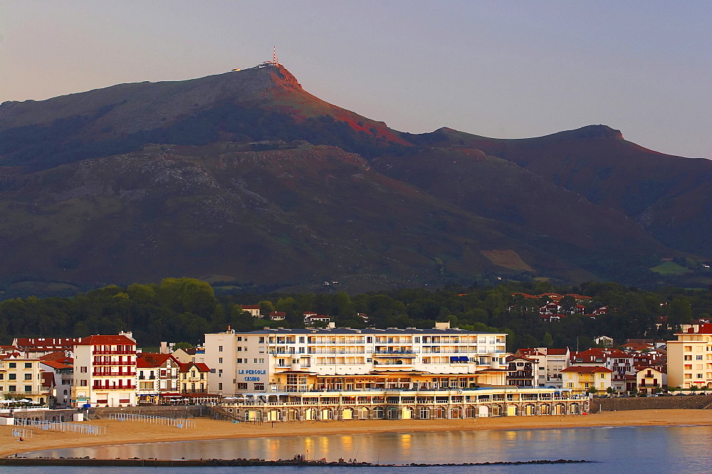 At sunset in the seaside resort St. Jean de Luz with Casino and view to La Rhune, Cote des Basques, dept PyrÃˆnÃˆes-Atlantiques, France, Europe