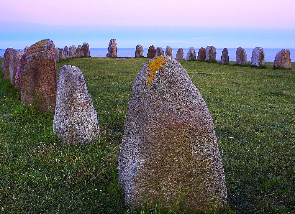 Ales stenar biggest old stone circle in form of a ship in Scandinavia near Kaseberga after sunset, Skane, Sweden