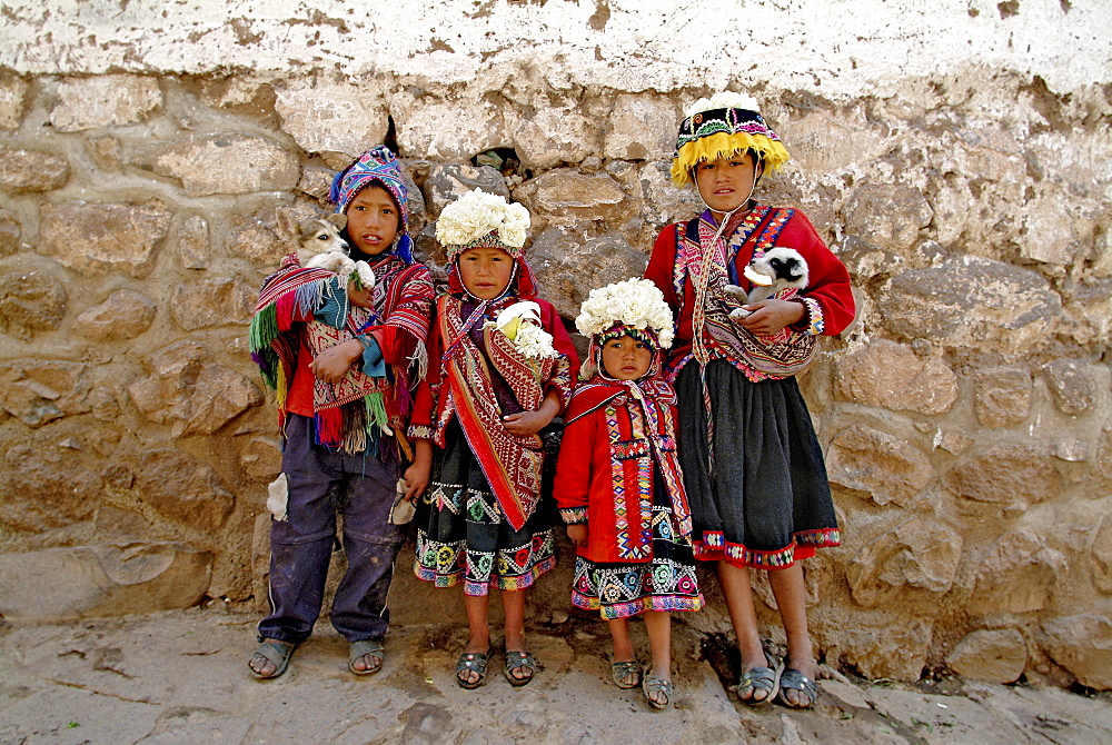 Inca children carrying pets in Pisac, Peru, South America