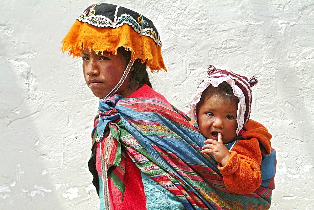 Young inca woman with baby in baby sling, Pisac, Peru, South America