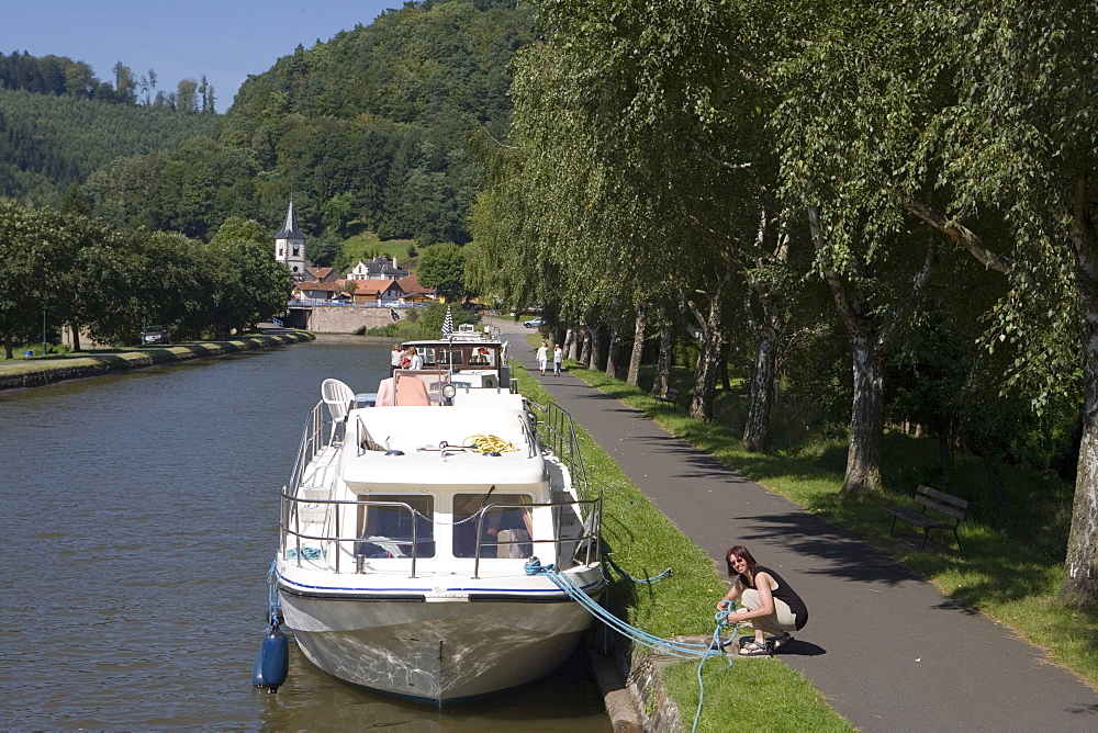 Woman Working Houseboat Mooring Lines, Crown Blue Line Calypso Houseboat, Canal de la Marne au Rhin, Lutzelbourg, Alsace, France