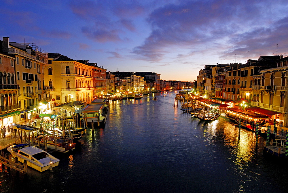 Canale Grande with illuminated houses and restasurants at dusk, Venice, Venezia, Italy