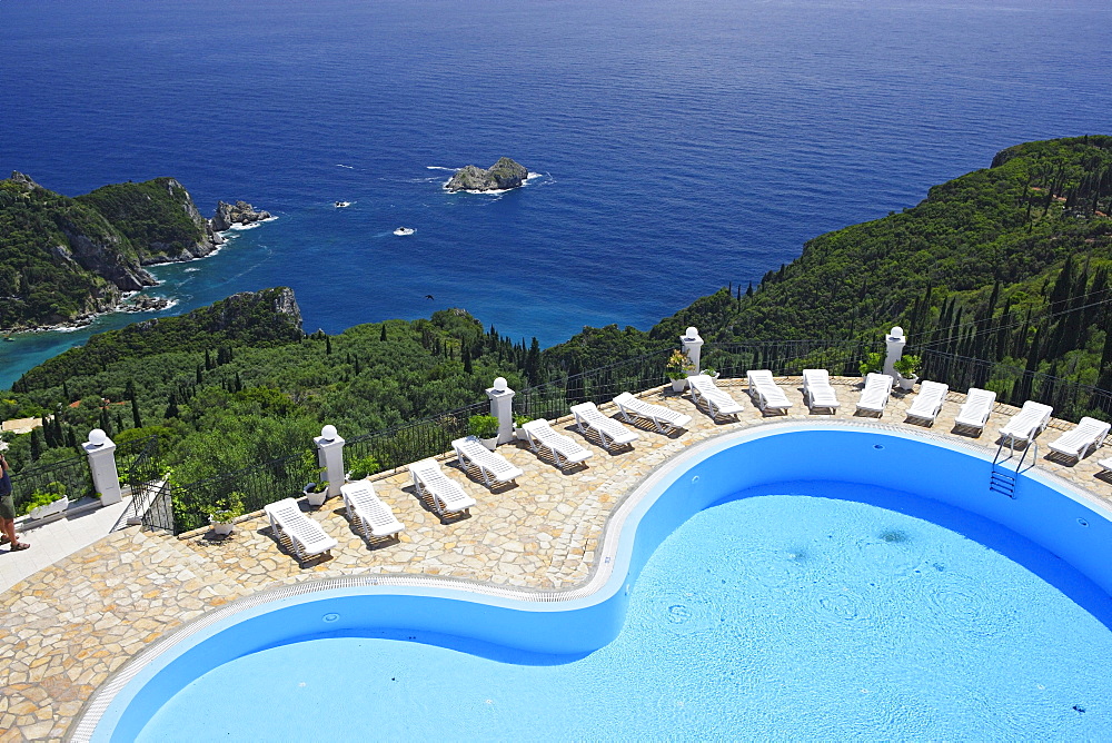 View of the pool of Golden Fox Hotel, coastal landscape in the background, Corfu, Ionian Islands, Greece